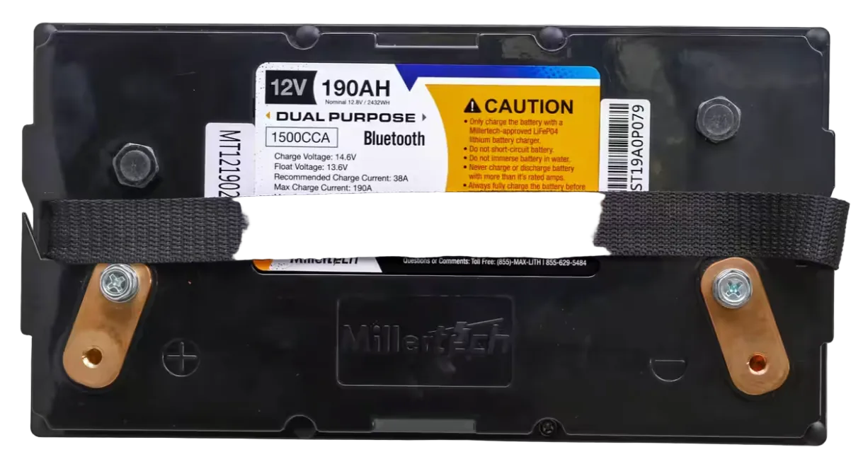 A 12V 190Ah dual-purpose MillerTech battery with a black plastic casing, a black strap across the middle, and copper-colored terminal caps on the sides. A white and yellow label is attached to the top, showing product details and Bluetooth compatibility.